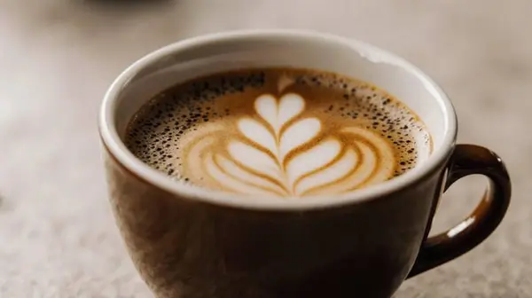 AI-generated image from a vague prompt — photo of a cup of coffee, generic result with no style direction
